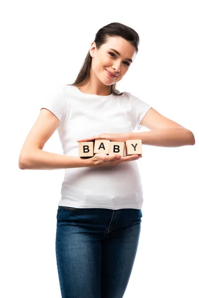 Mulher grávida em t-shirt branca segurando cubos de madeira com letras de bebê isolado em branco — Fotografia de Stock