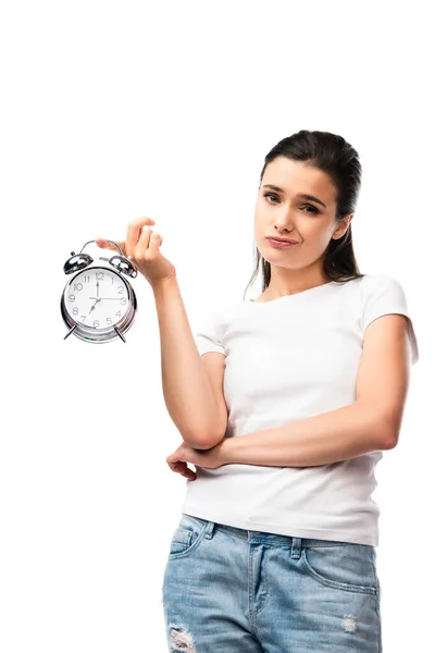 Young dissatisfied woman in white t-shirt holding retro alarm clock isolated on white — Stock Photo