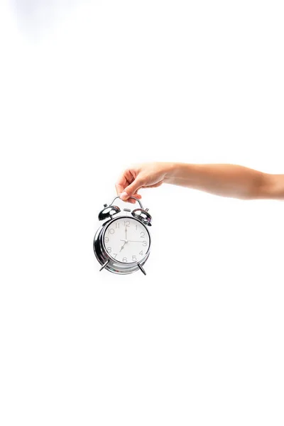 Partial view of woman holding vintage alarm clock isolated on white — Stock Photo