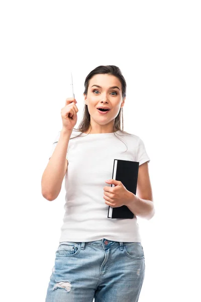 Brunette woman in white t-shirt holding notebook and pen while having idea isolated on white — Stock Photo