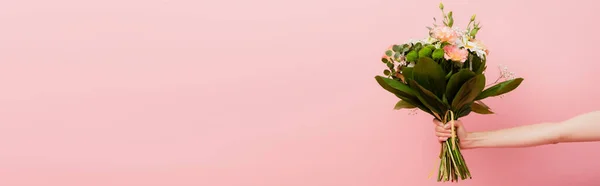 Partial view of woman holding bouquet of flowers isolated on pink, website header — Stock Photo