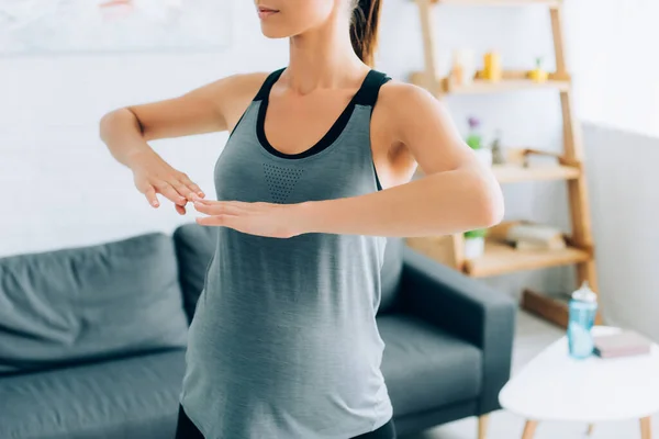 Cropped view of pregnant sportswoman training at home — Stock Photo