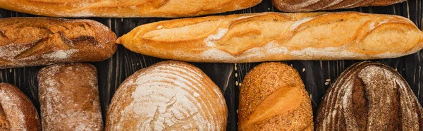 Top view of fresh baked bread loaves, panoramic shot — Stock Photo
