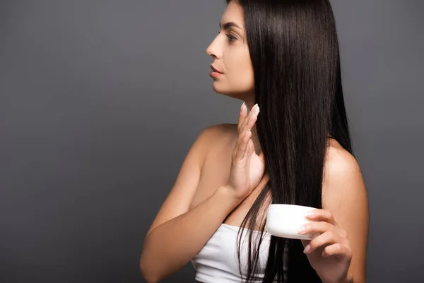 Brunette long haired woman holding hair mask isolated on black — Stock Photo