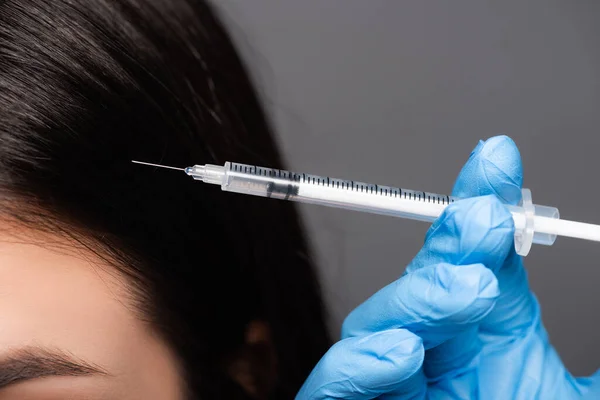 Close up view of brunette woman having scalp mesotherapy isolated on black — Stock Photo