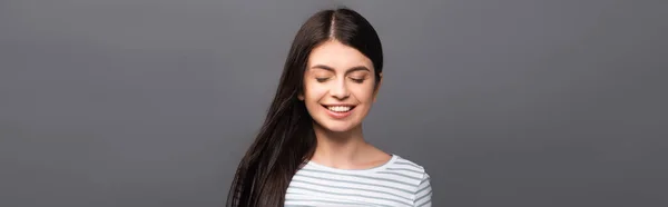 Morena de cabelos longos mulher com olhos fechados sorrindo isolado em preto, tiro panorâmico — Fotografia de Stock