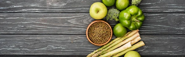 Top view of fresh green fruits and vegetables on wooden surface, panoramic shot — Stock Photo
