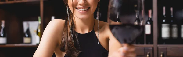 Image horizontale de la femme tenant un verre de vin dans un restaurant — Photo de stock