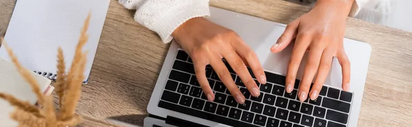 Top view of young woman typing on laptop at home, panoramic crop — Stock Photo