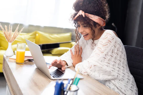 Selektiver Fokus der Frau, die lacht, während sie Laptop benutzt — Stockfoto