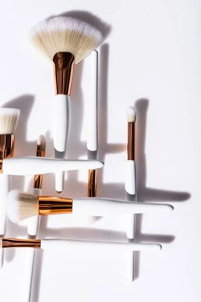 Flat lay with cosmetic brushes set on white background — Stock Photo