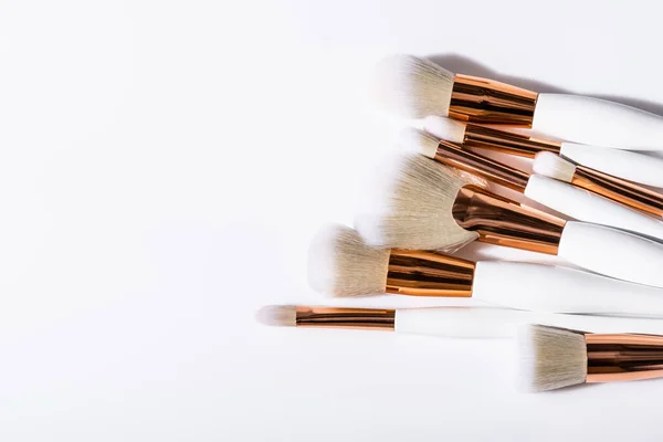 Top view of cosmetic brushes set on white background with copy space — Stock Photo