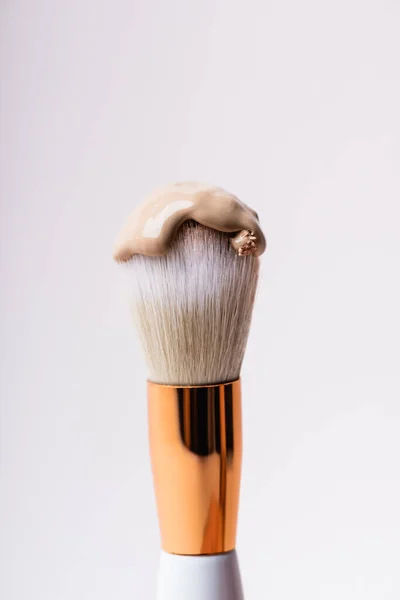 Close up view of cosmetic brush with face foundation isolated on white — Stock Photo