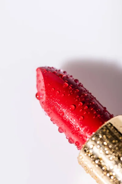 Close up view of red wet lipstick on white background — Stock Photo