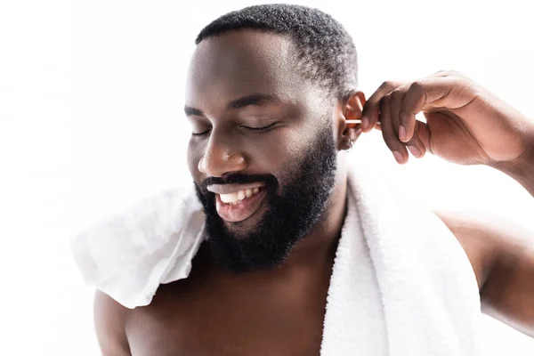 Portrait of afro-american man cleaning ears with pleasure — Stock Photo