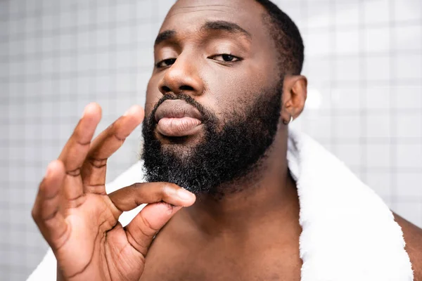 Ritratto dell'uomo afro-americano che usa la cura per rafforzare la crescita della barba — Foto stock