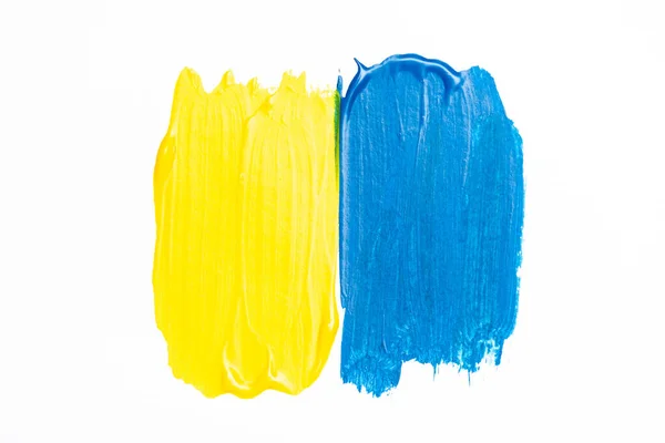 Top view of abstract colorful blue and yellow paint brushstrokes on white background — Stock Photo