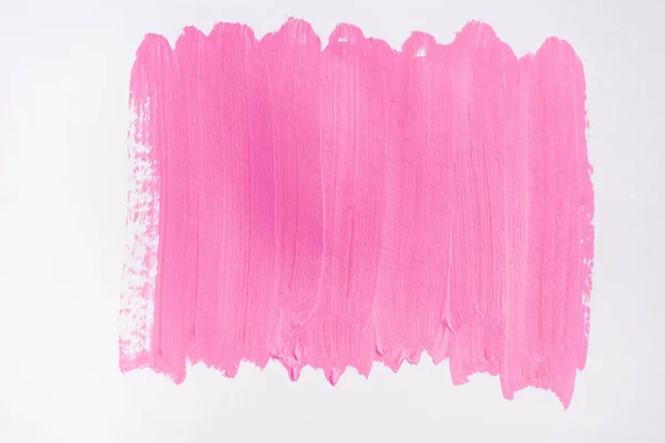 Top view of abstract pink paint brushstrokes on white background — Stock Photo