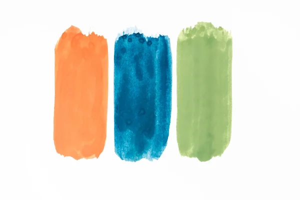 Top view of abstract colorful green, orange and blue paint brushstrokes on white background — Stock Photo