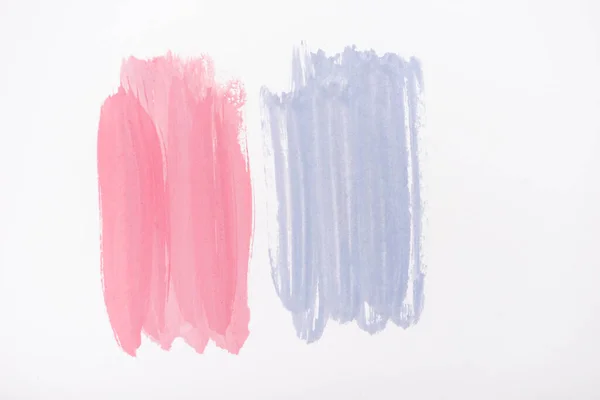 Top view of abstract pink and blue paint brushstrokes on white background — Stock Photo