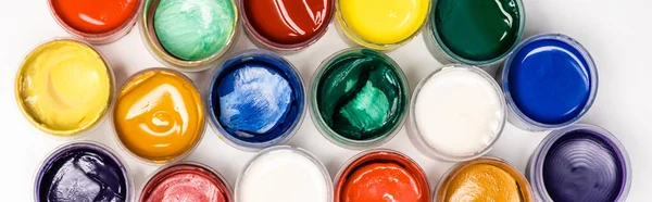 Top view of colorful Gouache paints on white background, panoramic shot — Stock Photo
