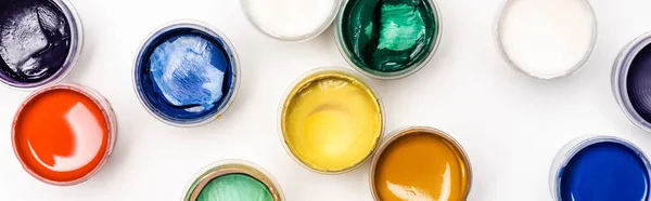 Top view of colorful Gouache paints on white background, panoramic shot — Stock Photo