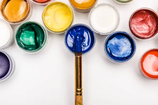 Top view of colorful Gouache paints and paintbrush on white background — Stock Photo