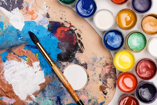 Top view of palette with Gouache paints and paintbrush — Stock Photo