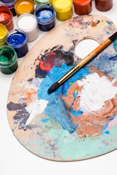 Palette with Gouache paints and paintbrush — Stock Photo