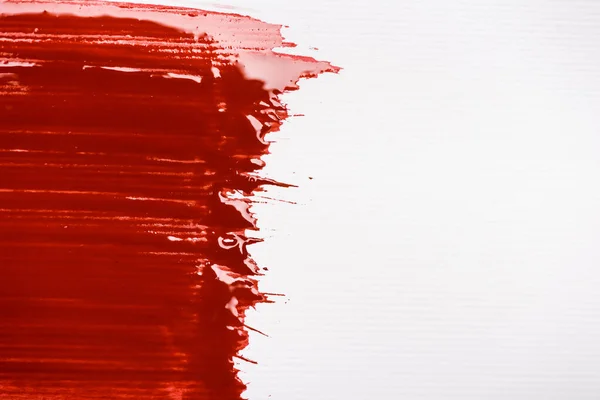 Top view of colorful red paint brushstroke on white background — Stock Photo