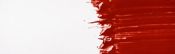 Top view of colorful red paint brushstroke on white background — Stock Photo