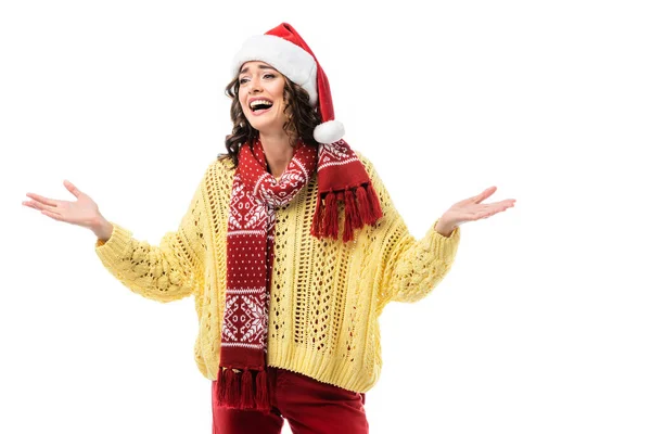 Excited woman in santa hat and scarf with ornament gesturing isolated on white — Stock Photo
