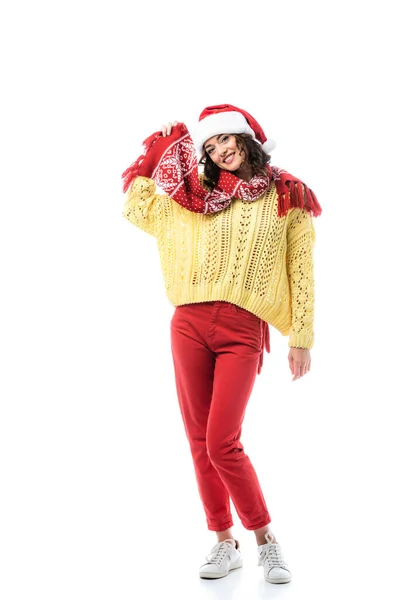 Young pleased woman in santa hat touching scarf with ornate isolated on white — Stock Photo