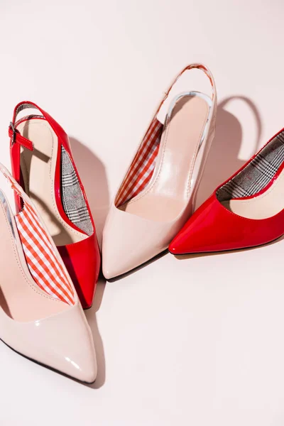 Leather heeled shoes on beige background — Stock Photo