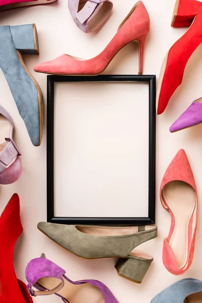 Top view of heeled shoes and empty frame on white background — Stock Photo