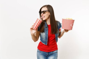 Portrait of young attractive woman in 3d glasses watching movie film, holding bucket of popcorn and drinking from plastic cup of soda or cola isolated on white background. Emotions in cinema concept clipart
