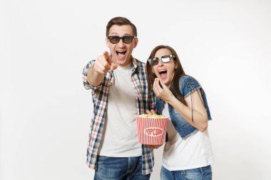 Genç mutlu gülen çift, kadın ve erkek 3d gözlük ve rahat kıyafetler tarihte, film film izlerken kova tutarak ve beyaz arka plan üzerinde izole patlamış mısır yemek. Sinema kavramı duygular