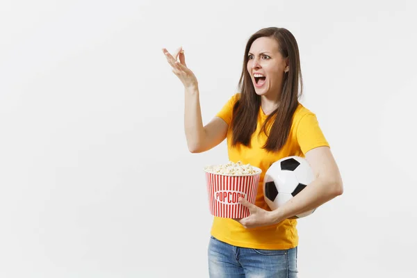 Screaming European woman, football fan holding soccer ball, bucket of popcorn upset of loss or goal of favorite team isolated on white background. Sport, play football, cheer, fans lifestyle concept