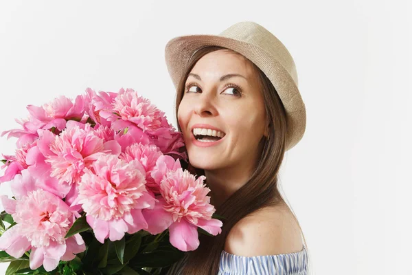 Close up young tender woman in blue dress, hat holding bouquet of pink peonies flowers isolated on white background. St. Valentine\'s Day, International Women\'s Day holiday concept. Advertising area