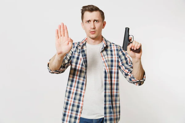 Man with gun in hand showing stop gesture with palm isolated on white background. Male hand no shooting symbol. Stop violence, weapons in school control, no killing people children, problem concept