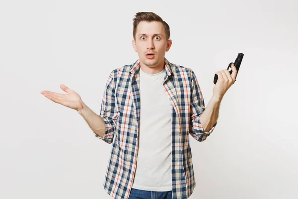Shocked sad upset young man with gun in hand isolated on white background. Male with handgun, no shooting symbol. Stop violence, weapons in school control, no killing people children, problem concept
