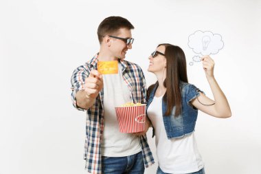 Young couple, woman and man in 3d glasses watching movie film on date holding bucket of popcorn, say cloud with lightbulb, idea and credit card isolated on white background. Emotions in cinema clipart