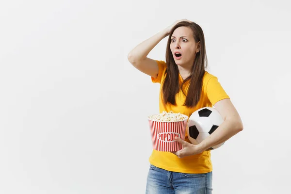 Screaming European woman, football fan holding soccer ball, bucket of popcorn upset of loss or goal of favorite team isolated on white background. Sport, play football, cheer, fans lifestyle concept