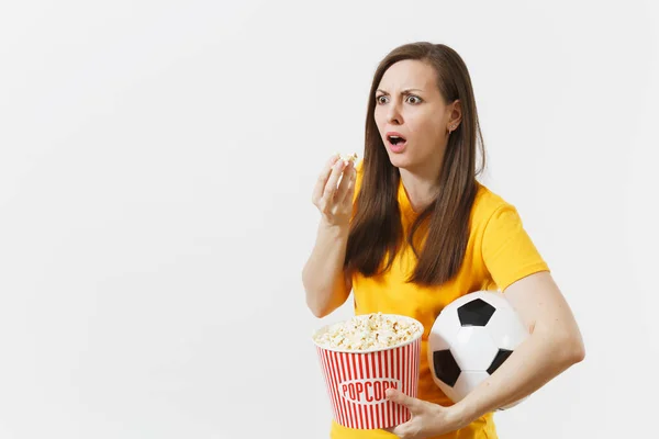 Screaming European woman, football fan holding soccer ball, bucket of popcorn upset of loss or goal of favorite team isolated on white background. Sport, play football, cheer, fans lifestyle concept