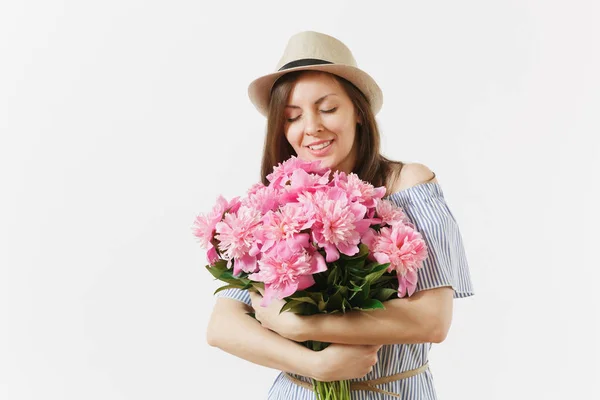 Young tender woman in blue dress, hat holding bouquet of beautiful pink peonies flowers isolated on white background. St. Valentine\'s Day, International Women\'s Day holiday concept. Advertising area