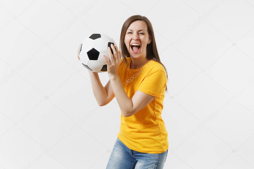 Happy European young woman, football fan or player in yellow uniform holding soccer ball support favorite team isolated on white background. Sport, play football, cheer, fans people lifestyle concept