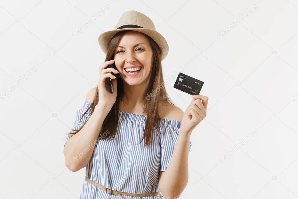Young pretty woman in blue dress, hat talking on mobile phone, conducting pleasant conversation, holding credit card isolated on white background. People banking concept. Advertising area. Copy space
