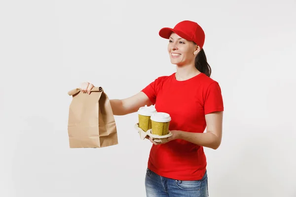 Woman in red cap, t-shirt giving fast food order isolated on white background. Female courier holding paper packet with food, coffee. Products delivery from shop or restaurant to home. Copy space