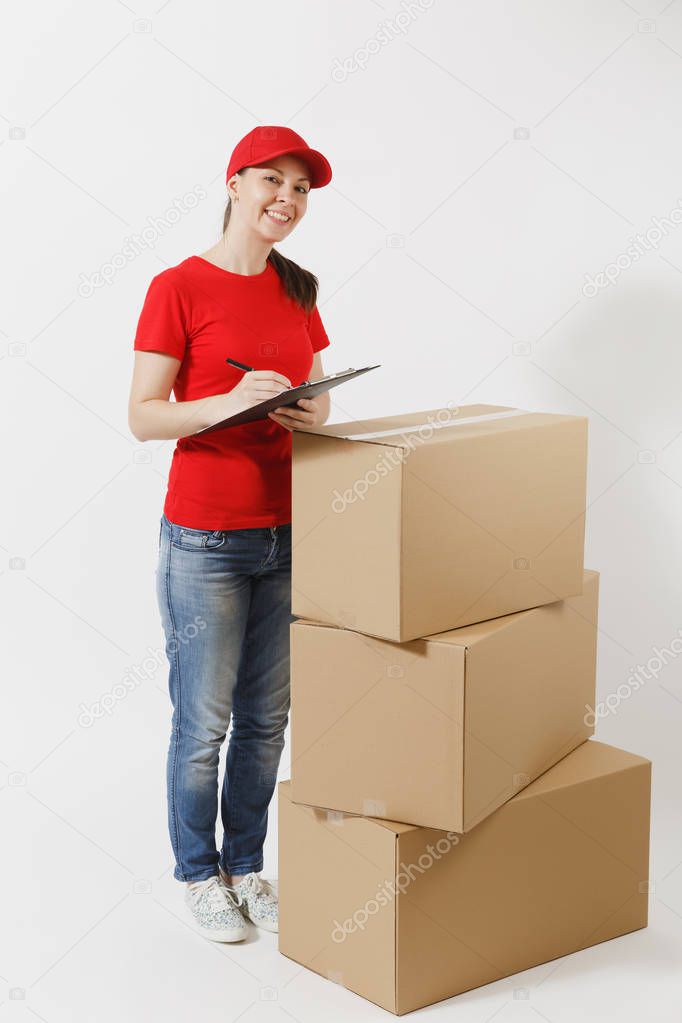Full length of delivery woman in red cap, t-shirt isolated on white background. Female courier holding clipboard with papers document, blank empty sheet on empty cardboard boxes. Receiving package