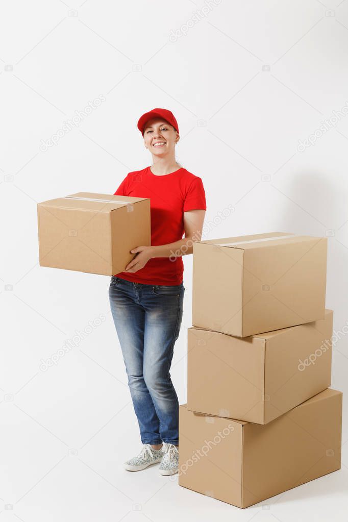 Full length portrait of delivery woman in red cap, t-shirt giving order boxes isolated on white background. Female courier near empty cardboard boxes. Receiving package. Copy space for advertisement